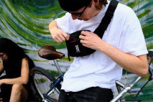 Man in white tee wearing black Wonder Goods fanny pack