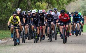 Group of bike riders racing on dirt road