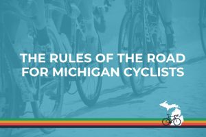 The Rules of the Road for Michigan Cyclists over blue background with biker's feet